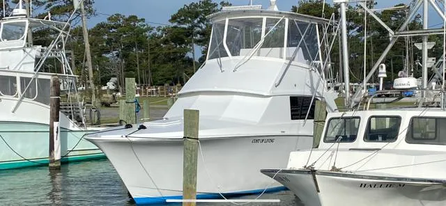 Slide: The Image of 1985 Bertram 38 Convertible yacht docked at marina. - 6