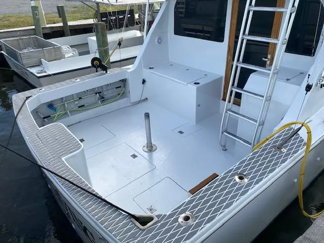 Slide: The Image of 1985 Bertram 38 Convertible boat deck with ladder and storage compartments. - 9