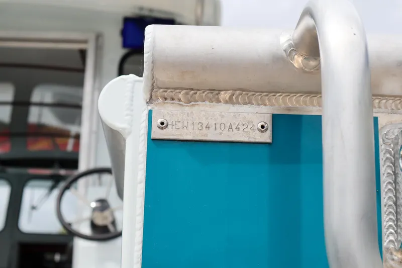 Slide: The Image of 2024 Hewescraft 270 Pacific Explorer boat with visible identification plate. - 19