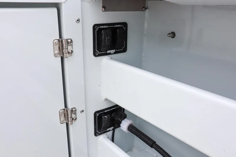 Slide: The Image of 2024 Hewescraft 270 Pacific Explorer interior storage compartment with electrical outlets. - 8