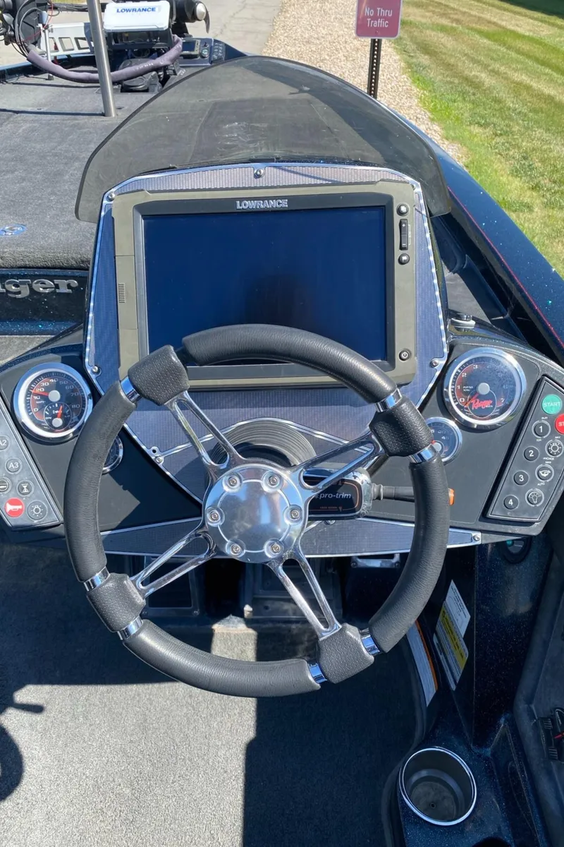 Slide: The Image of 2015 Ranger Z521C boat dashboard with steering wheel and navigation system. - 1