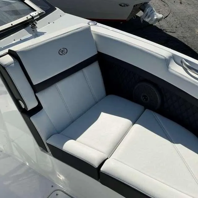 Slide: The Image of 2025 Cobalt R8 boat interior with white and black cushioned seating. - 10