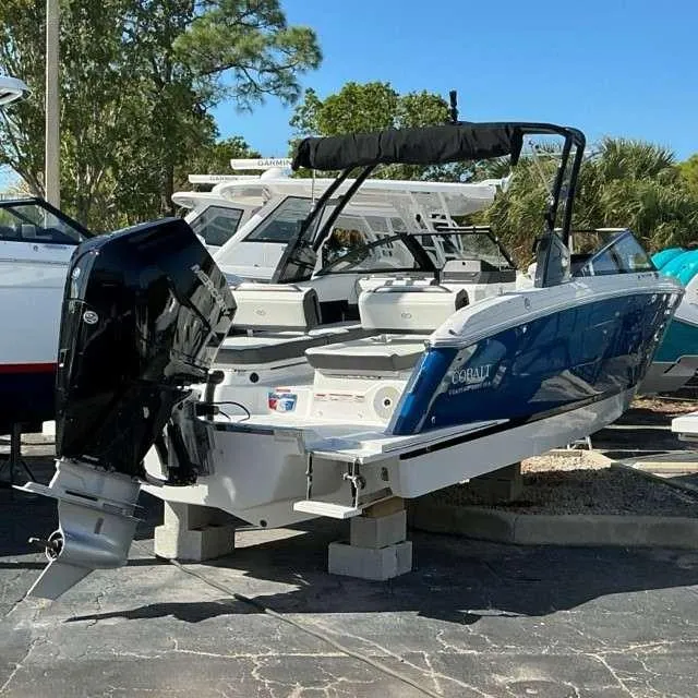 Slide: The Image of 2025 Cobalt R8 boat with outboard motor on display in a marina. - 3