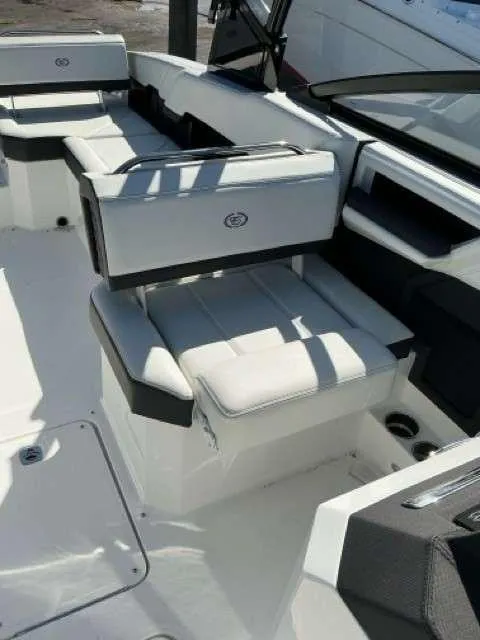 Slide: The Image of 2025 Cobalt R8 boat interior with white cushioned seating and sleek design. - 7