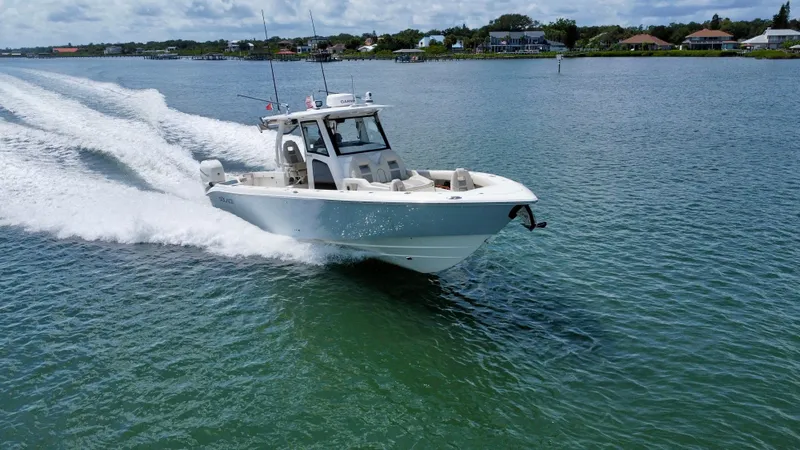 Slide: The Image of 2020 Solace 345 boat cruising on a sunny day in a scenic waterway. - 1