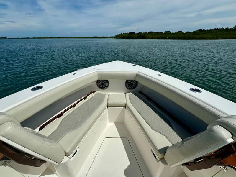 Slide: The Image of Solace 345 boat interior, 2020 model, with cushioned seating and scenic water view. - 28