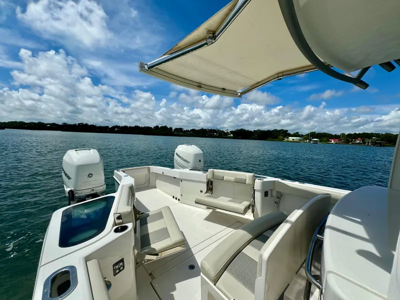 Slide: The Image of 2020 Solace 345 boat with spacious deck and seating on a sunny day. - 35