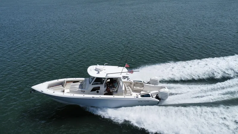 Slide: The Image of 2020 Solace 345 boat cruising on open water, creating a wake. - 4