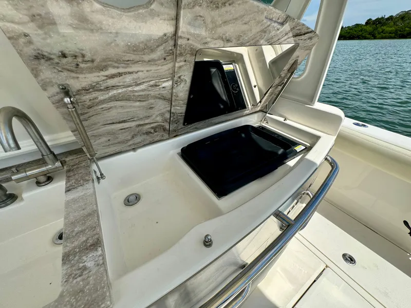 Slide: The Image of Luxury boat kitchen area with marble countertop, sink, and scenic water view. Solace 345, 2020 model. - 46