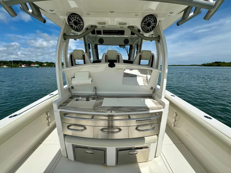 Slide: The Image of 2020 Solace 345 boat interior with sleek kitchen setup on open water. - 48