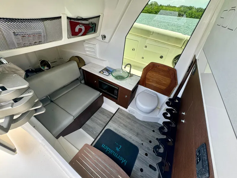 Slide: The Image of Interior of 2020 Solace 345 boat with seating, kitchenette, and toilet. - 49
