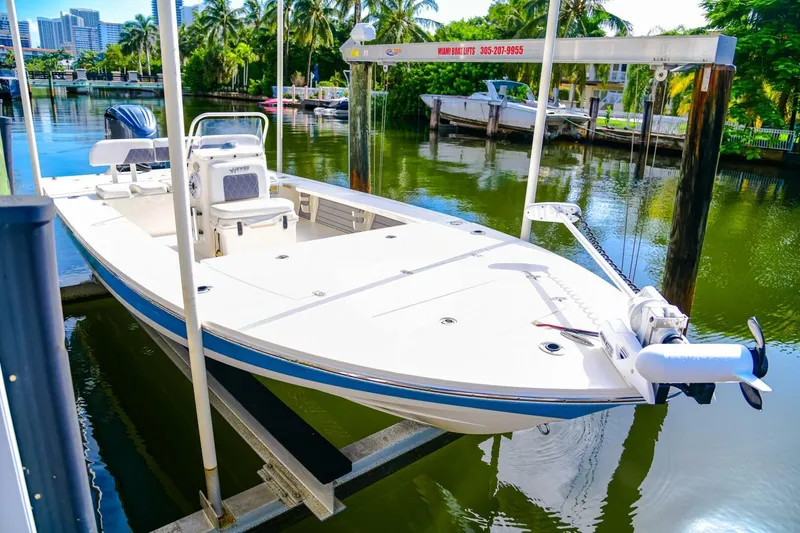 Slide: The Image of 2022 Hewes Redfisher 21 boat on lift, docked in a scenic marina. - 10
