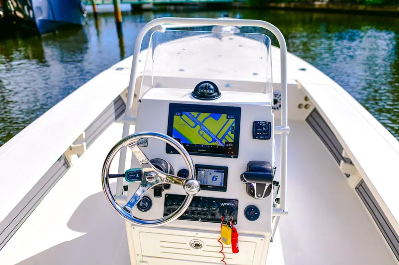 Slide: The Image of 2022 Hewes Redfisher 21 boat console with navigation system and steering wheel. - 11