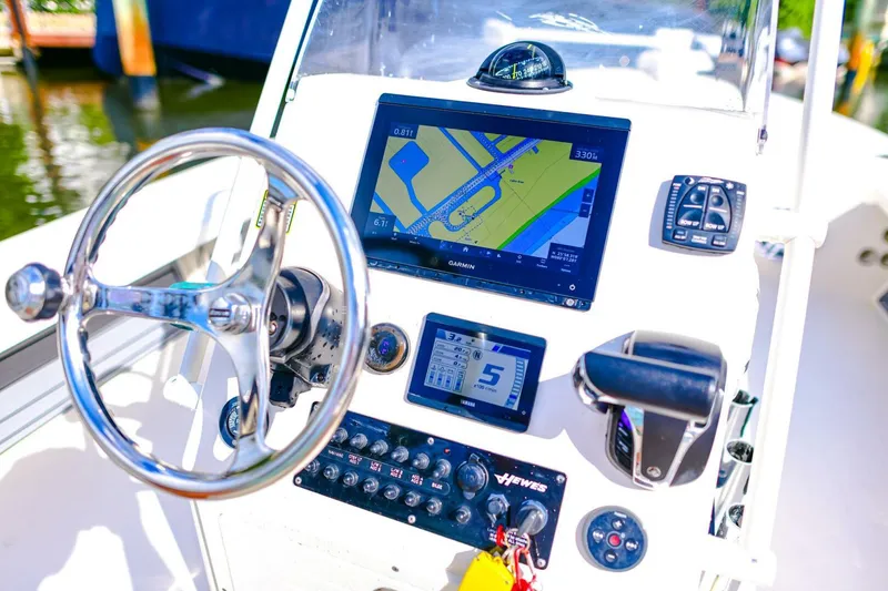 Slide: The Image of 2022 Hewes Redfisher 21 boat dashboard with navigation system and steering wheel. - 12