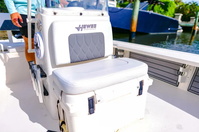 Slide: The Image of 2022 Hewes Redfisher 21 boat interior with cushioned seating and storage. - 15