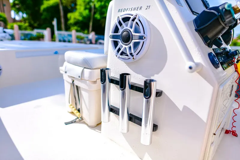 Slide: The Image of 2022 Hewes Redfisher 21 boat interior with rod holders and speaker. - 17