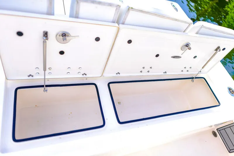 Slide: The Image of 2022 Hewes Redfisher 21 boat storage compartments, open and empty, with white interior. - 20