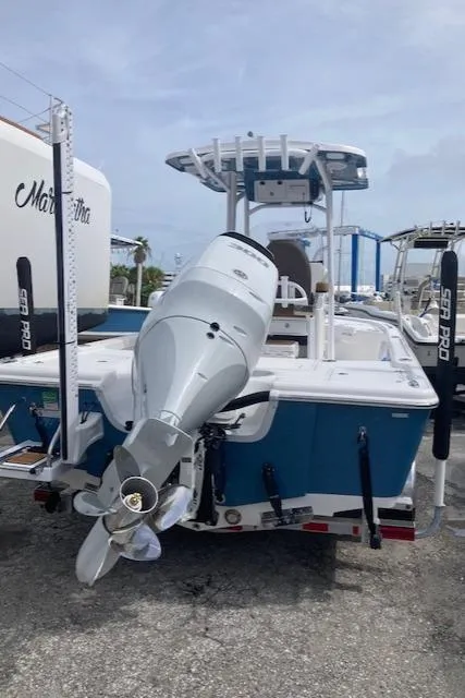 Slide: The Image of 2025 Sea Pro 250 DLX boat with outboard motor, docked on a trailer. - 1