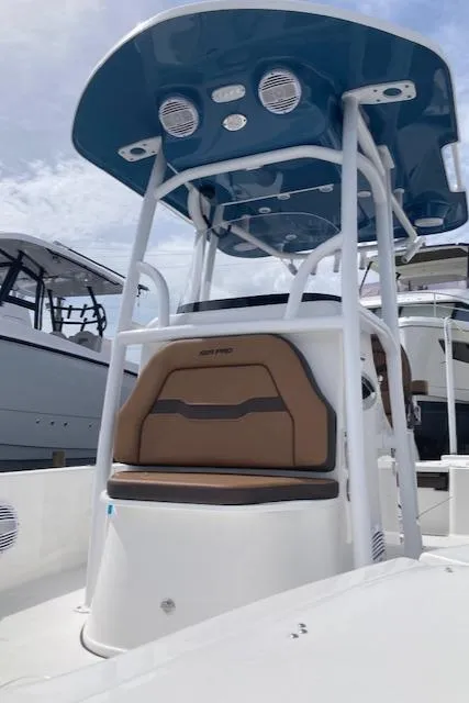 Slide: The Image of 2025 Sea Pro 250 DLX boat with blue T-top and tan seating. - 3