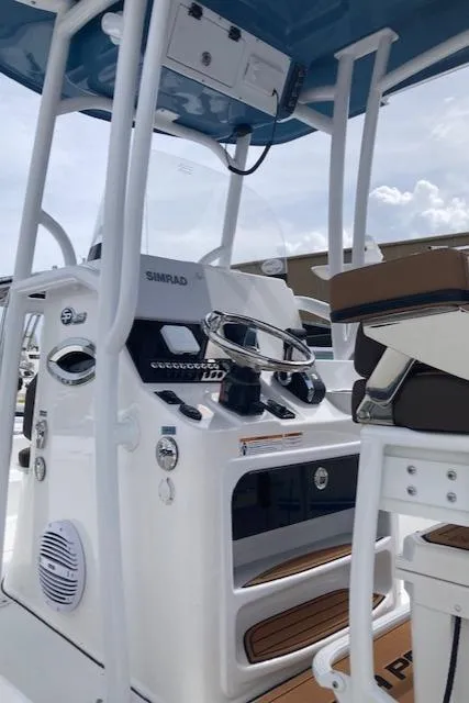 Slide: The Image of 2025 Sea Pro 250 DLX boat console with modern controls and seating. - 4