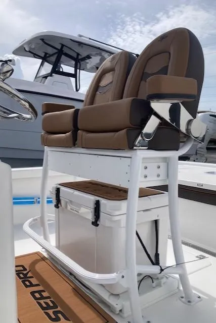 Slide: The Image of 2025 Sea Pro 250 DLX boat with cushioned seating and storage. - 5