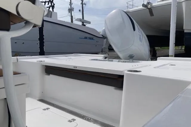 Slide: The Image of 2025 Sea Pro 250 DLX boat with outboard motor, docked in a marina. - 7