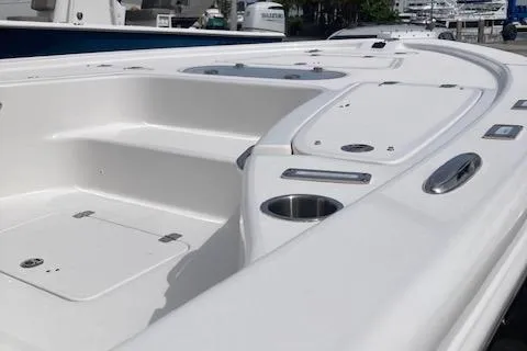 Slide: The Image of 2025 Sea Pro 250 DLX boat deck with storage compartments and cup holder. - 8