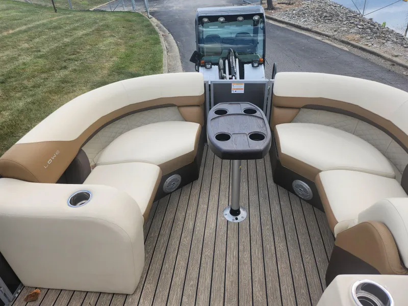 Slide: The Image of 2022 Lowe SS 210 CL pontoon boat with beige seating and central table. - 19