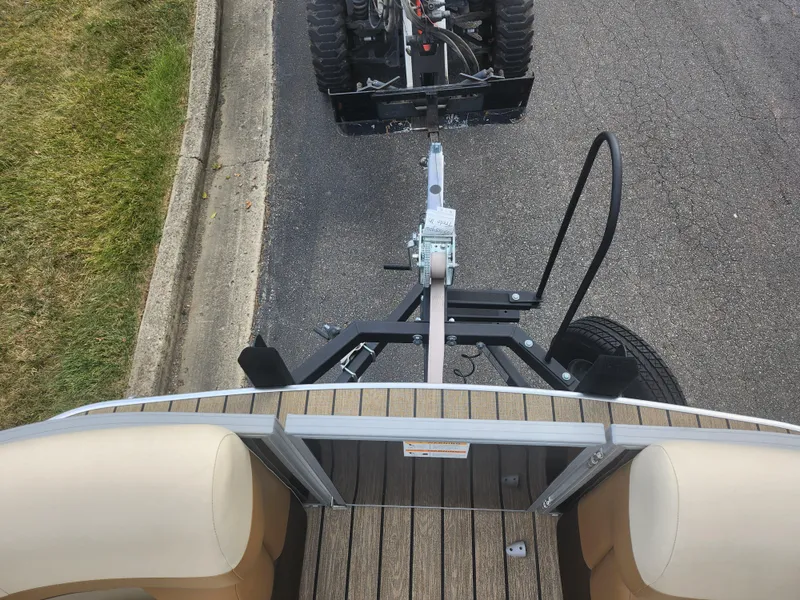 Slide: The Image of 2022 Lowe SS 210 CL boat trailer hitching to a vehicle on a paved road. - 20