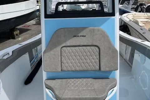 Slide: The Image of 2025 Sea Pro 242 DLX boat interior with gray cushioned seating. - 10