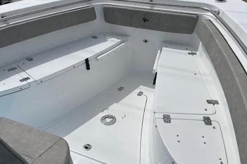 Slide: The Image of 2025 Sea Pro 242 DLX boat interior with spacious seating and storage. - 11