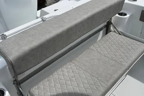 Slide: The Image of 2025 Sea Pro 242 DLX boat seating with gray upholstery and quilted design. - 5