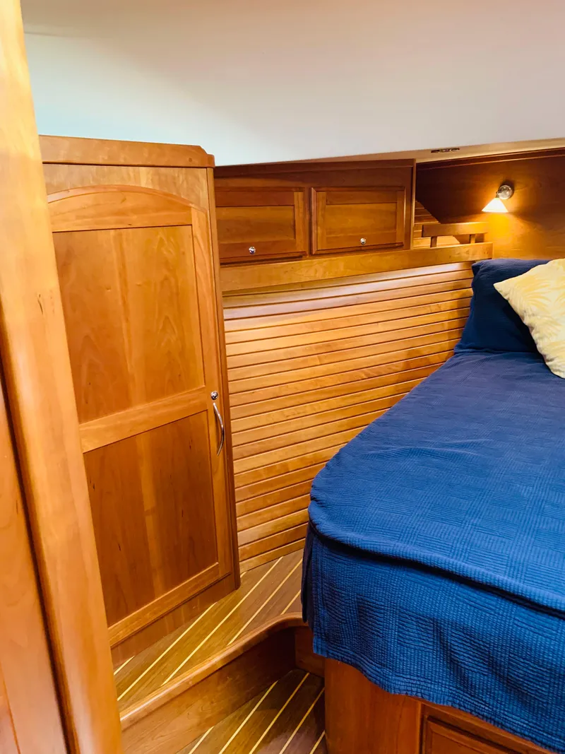 Slide: The Image of 2014 Sabre 48 Salon Express cabin with wooden interior and cozy bedding. - 14