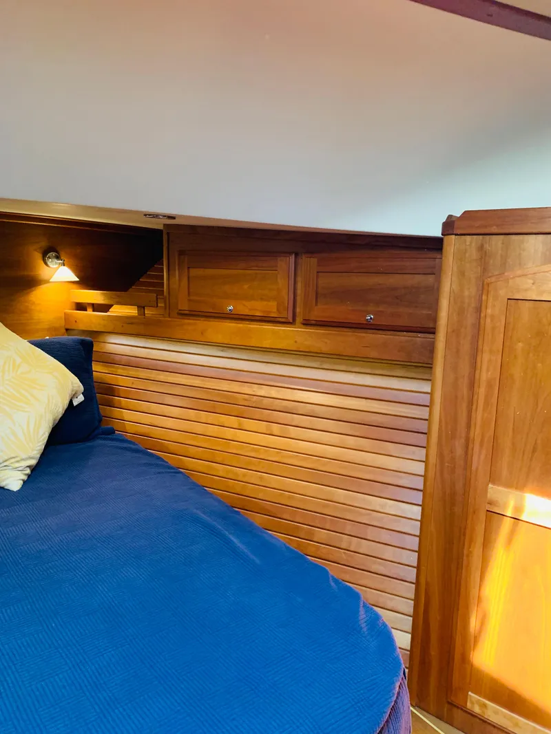 Slide: The Image of 2014 Sabre 48 Salon Express cabin with wooden interior and cozy bedding. - 16