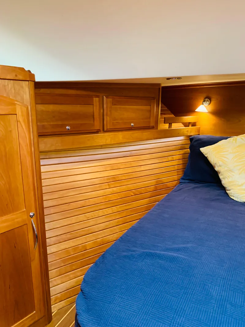 Slide: The Image of 2014 Sabre 48 Salon Express cabin with wooden interior and cozy bedding. - 17