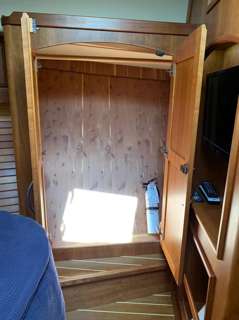 Slide: The Image of Open wooden closet in 2014 Sabre 48 Salon Express yacht interior. - 20