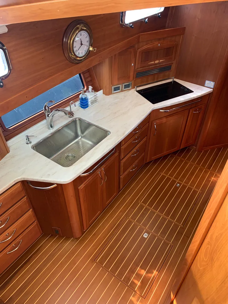 Slide: The Image of 2014 Sabre 48 Salon Express kitchen with wood cabinetry and modern appliances. - 25