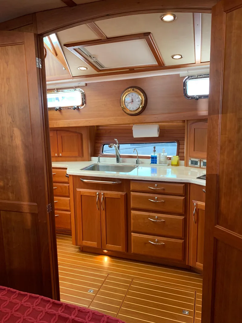 Slide: The Image of Interior of 2014 Sabre 48 Salon Express yacht kitchen with wooden cabinetry and modern fixtures. - 30