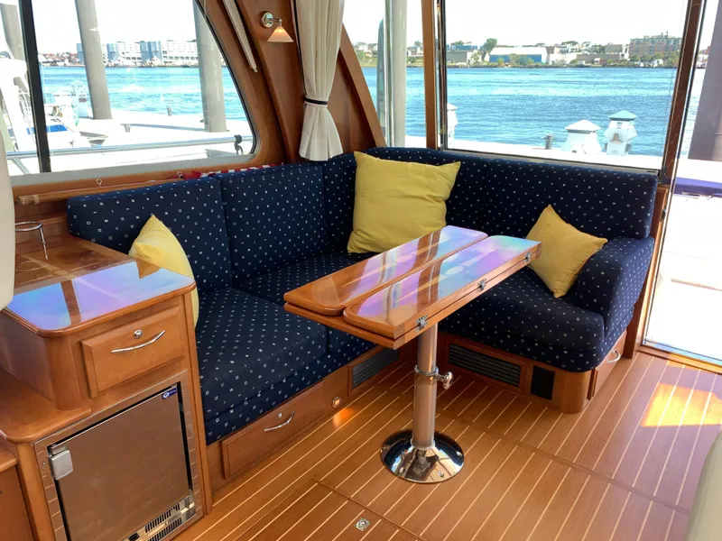 Slide: The Image of Interior of 2014 Sabre 48 Salon Express with blue seating and wooden table. - 33