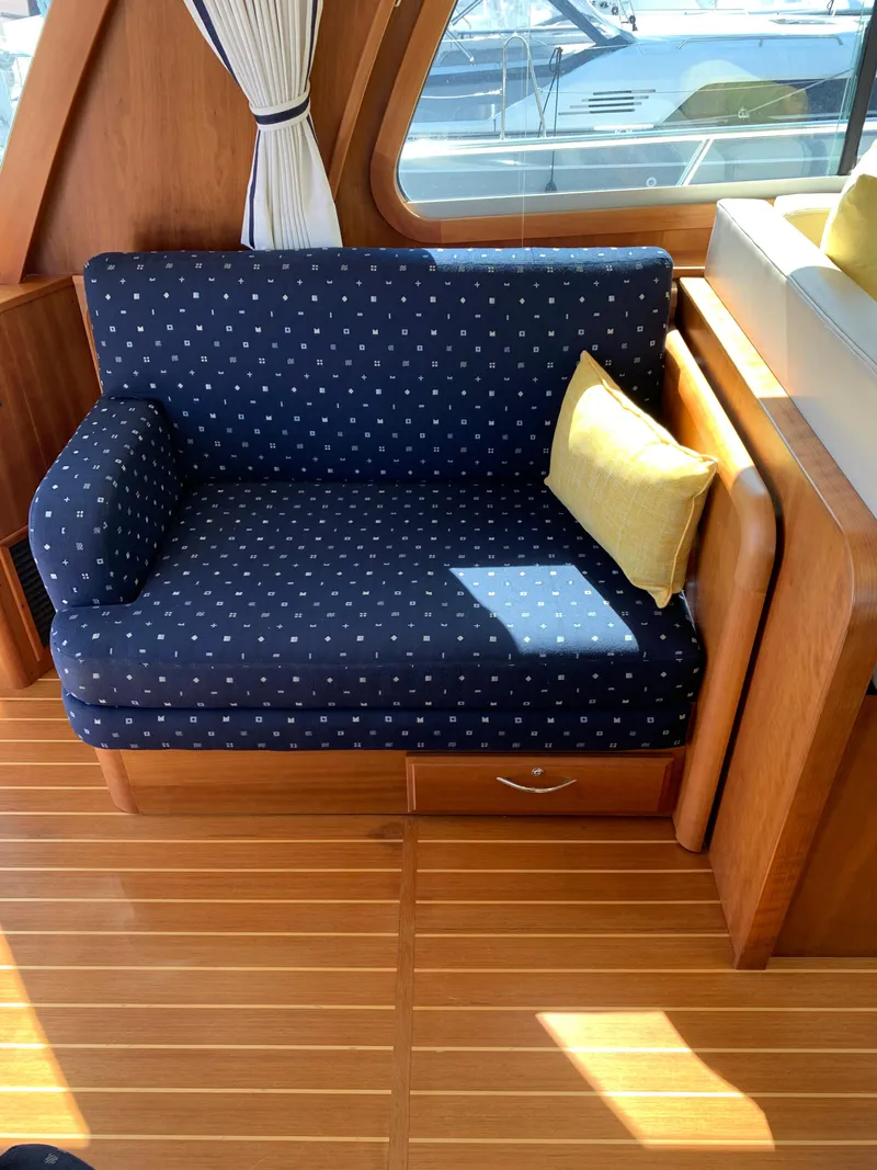 Slide: The Image of Interior of 2014 Sabre 48 Salon Express with blue polka dot sofa and wooden flooring. - 34