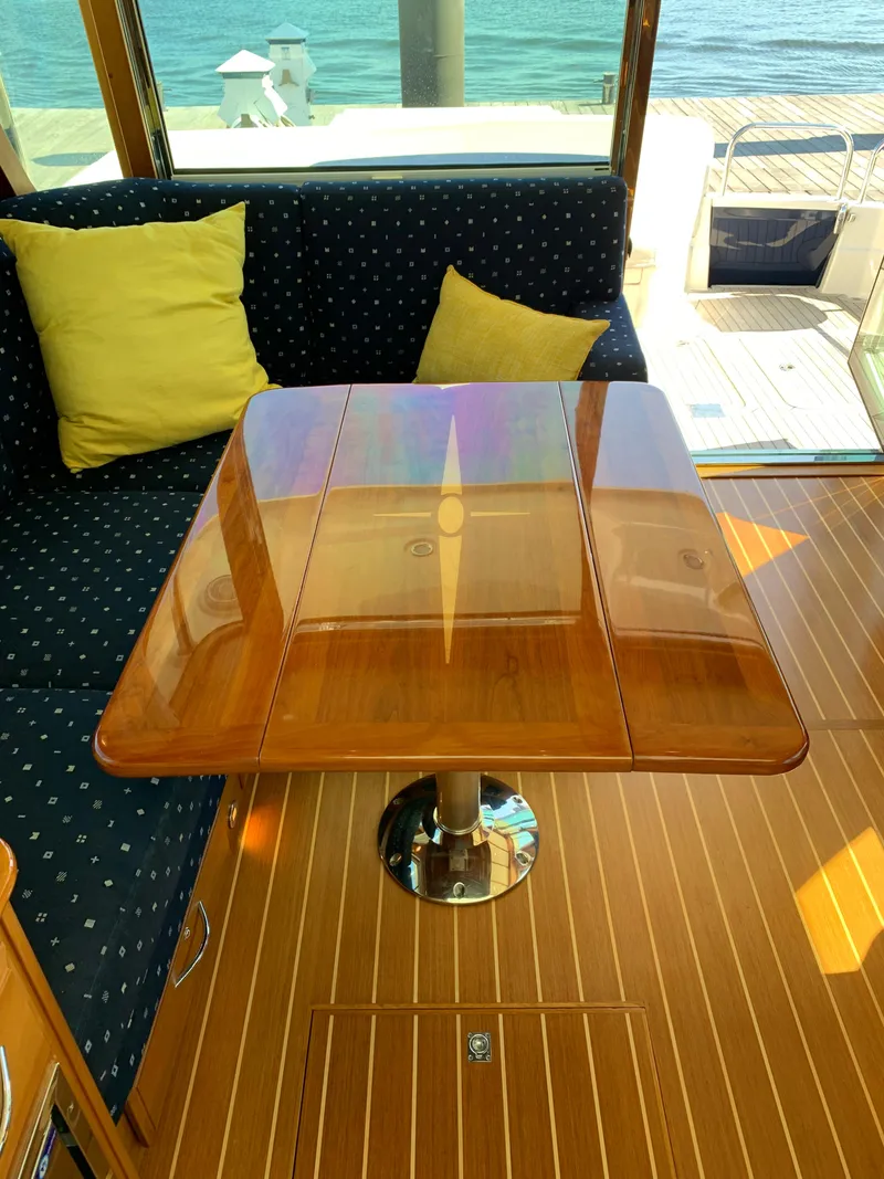 Slide: The Image of Interior of 2014 Sabre 48 Salon Express with polished wood table and cushioned seating. - 37