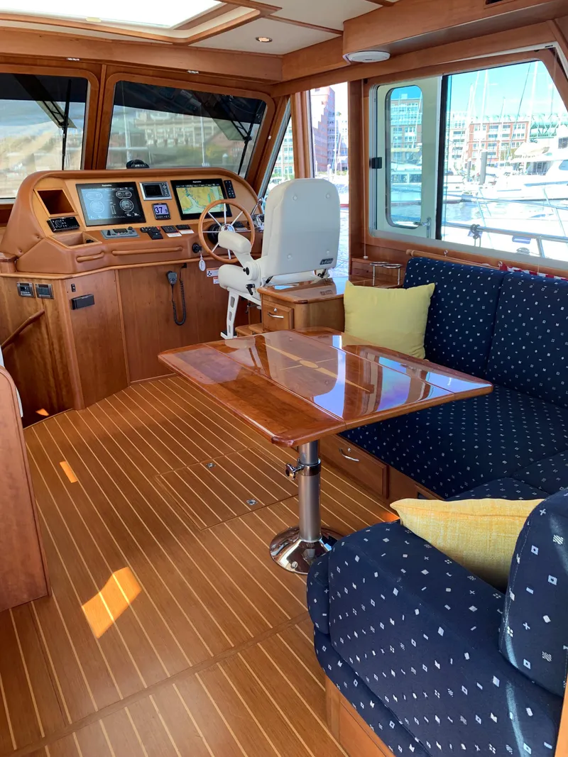 Slide: The Image of Interior of 2014 Sabre 48 Salon Express yacht with wood finish and plush seating. - 38