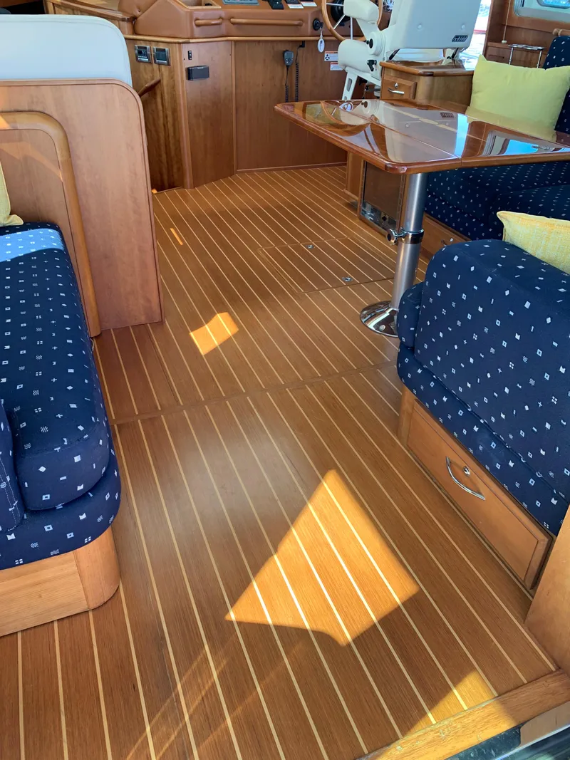Slide: The Image of Interior of 2014 Sabre 48 Salon Express with wooden flooring and blue cushioned seating. - 39