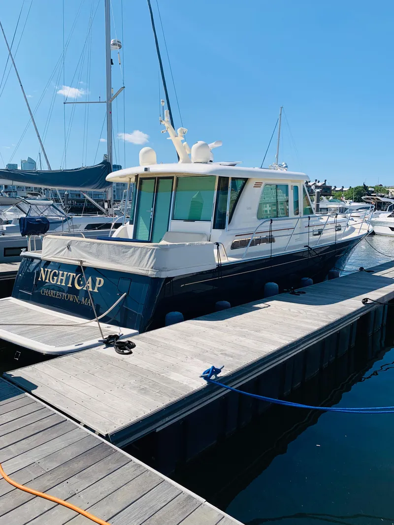 Slide: The Image of 2014 Sabre 48 Salon Express yacht docked at marina under clear blue sky. - 4