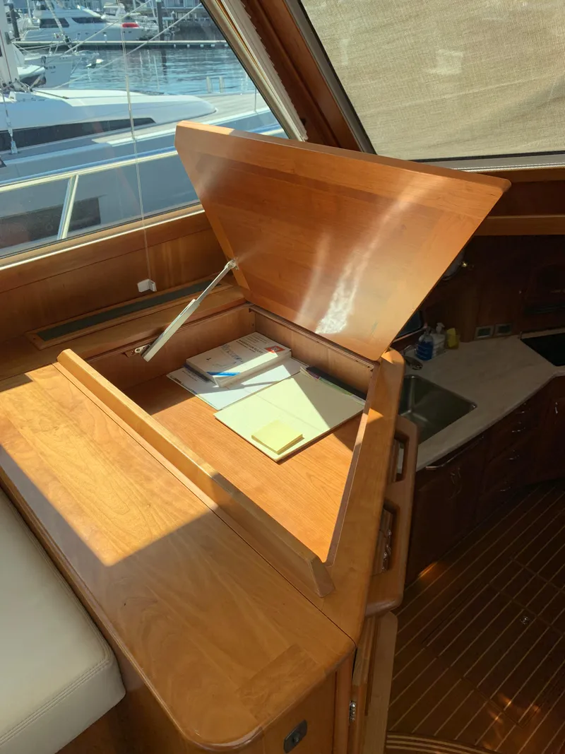 Slide: The Image of 2014 Sabre 48 Salon Express interior with open wooden storage compartment. - 41