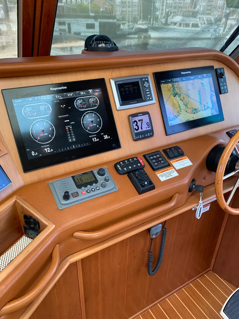 Slide: The Image of 2014 Sabre 48 Salon Express helm with navigation displays and controls. - 43
