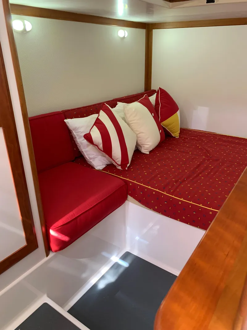 Slide: The Image of 2014 Sabre 48 Salon Express interior with red and white cushions. - 49