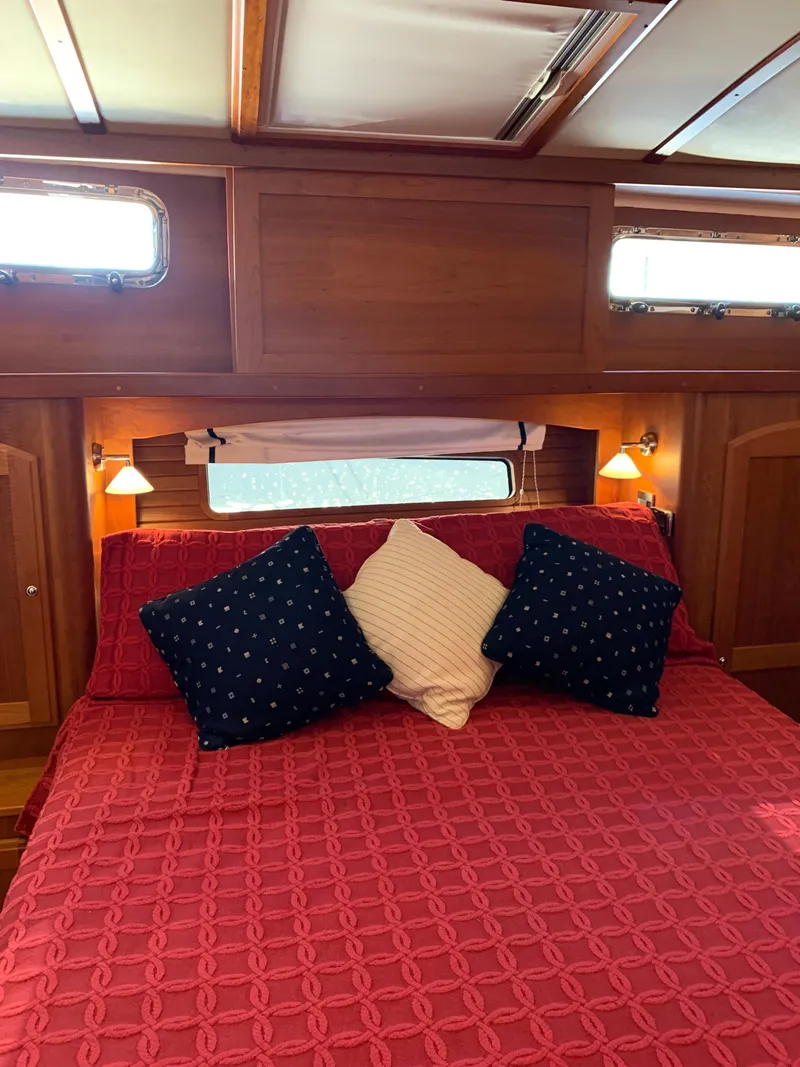 Slide: The Image of Cozy bedroom in 2014 Sabre 48 Salon Express yacht with red bedding and decorative pillows. - 7