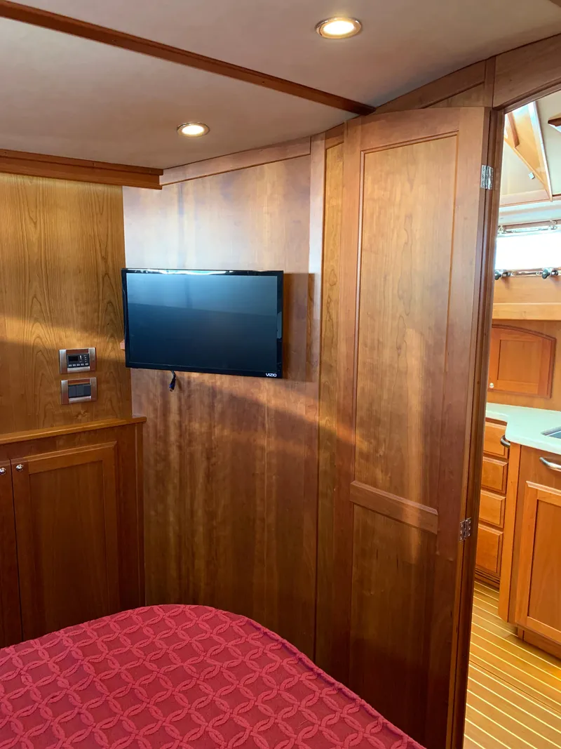 Slide: The Image of 2014 Sabre 48 Salon Express interior with wood paneling and mounted TV. - 9