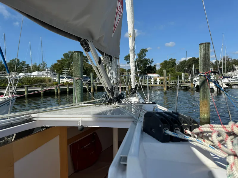 Slide: The Image of 2018 Catalina 275 Sport sailboat docked at a marina, showcasing rigging and deck details. - 29